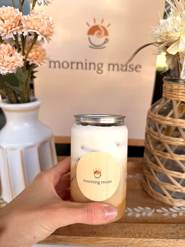 Holding a Morning Muse iced coffee